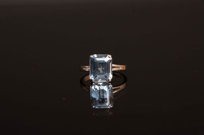White gold ring set with an emerald-cut aquamarine...