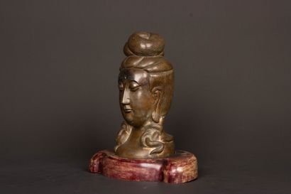 Patinated bronze Buddha head on wooden base....