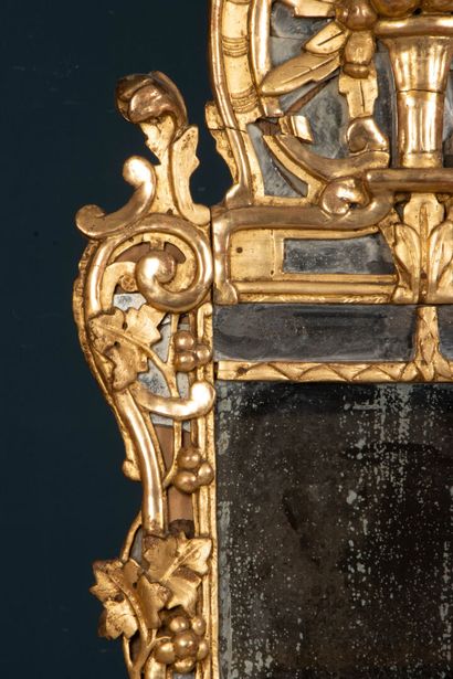 Wood and gilded stucco mirror with a pediment...