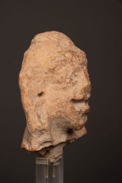 INDIA 
Terracotta head, almond-shaped eyes...
