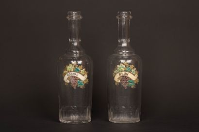 Two glass decanters with enameled vine blossom...