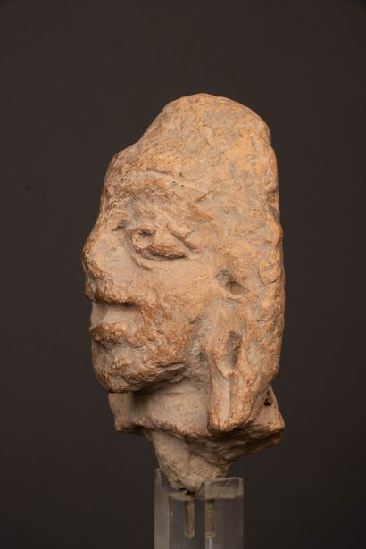 INDIA 
Terracotta head, almond-shaped eyes...