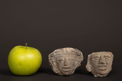 Reunion of two carved stone fragments depicting...