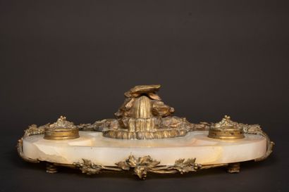 A desk with an alabaster top, bronze sculpture...