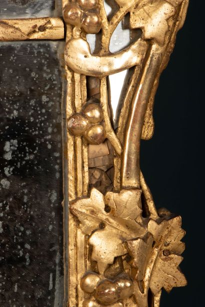 Wood and gilded stucco mirror with a pediment...