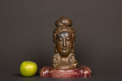 Patinated bronze Buddha head on wooden base....