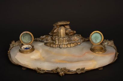 A desk with an alabaster top, bronze sculpture...