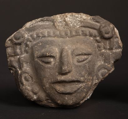 Reunion of two carved stone fragments depicting...
