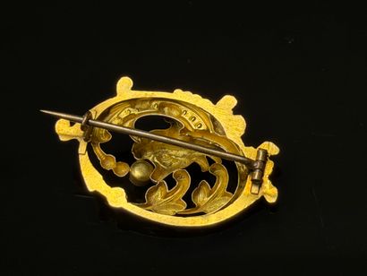 Gold brooch featuring a chimera head with...
