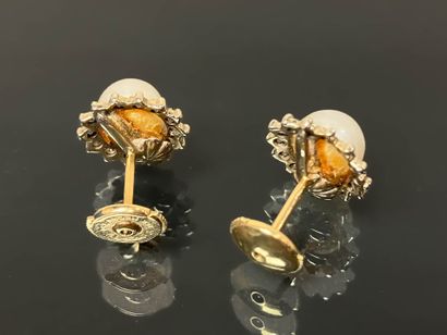Pair of gold stud earrings adorned with a...