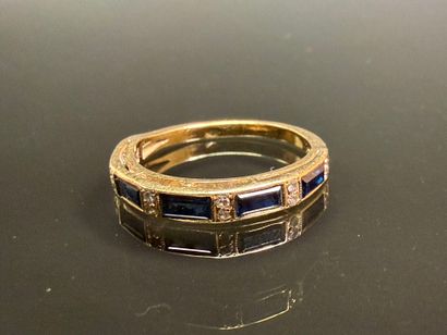 Gold wedding ring set with calibrated sapphires...
