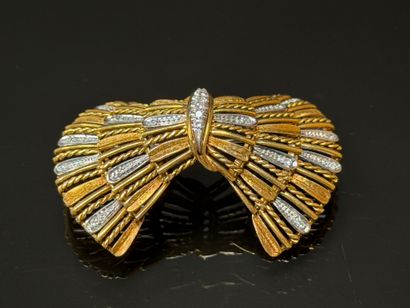 White gold and diamond brooch featuring a...