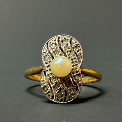 Gold ring set with a cultured pearl surrounded...