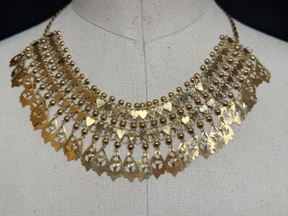 Gold choker necklace with radiating pendants.
Indian...
