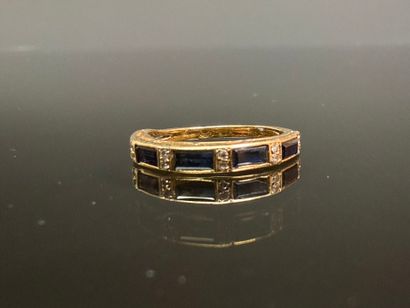 Gold wedding ring set with calibrated sapphires...