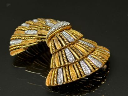 White gold and diamond brooch featuring a...