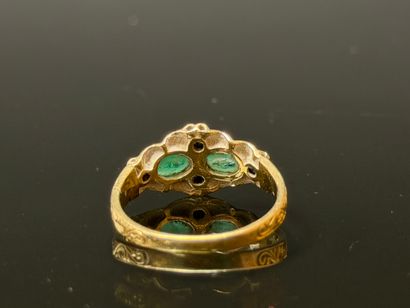 Gold ring set with two oval emeralds and...
