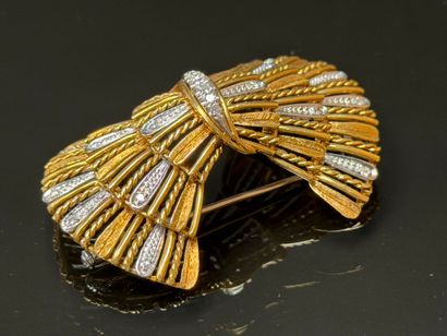 White gold and diamond brooch featuring a...