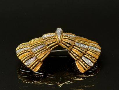 White gold and diamond brooch featuring a...
