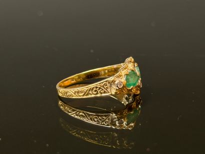 Gold ring set with two oval emeralds and...