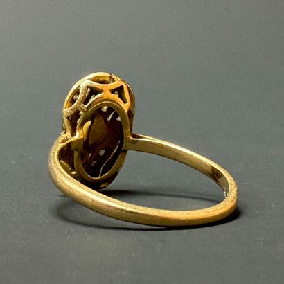 Gold ring set with a cultured pearl surrounded...