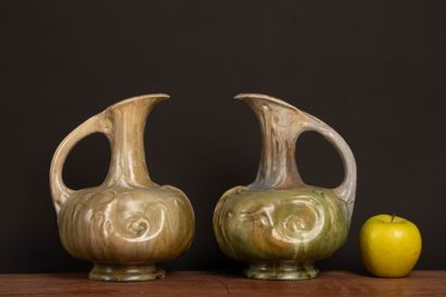 Pair of glazed stoneware pitchers.
Designed...