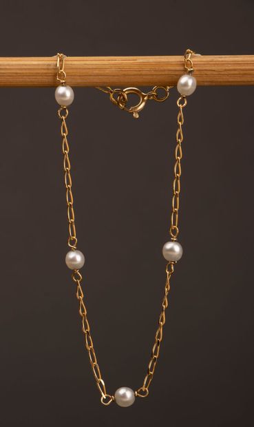 Gold bracelet accented with pearls and a...