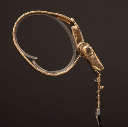 Gold wristwatch featuring a belt motif, accented...