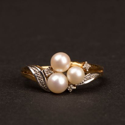 Gold ring set with three cultured pearls...