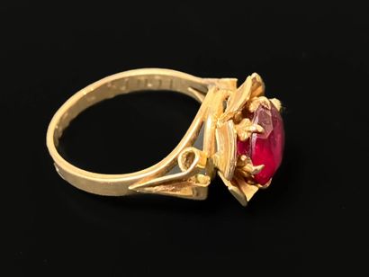 Gold ring set with a red stone.
750°/00 gold
TDD...