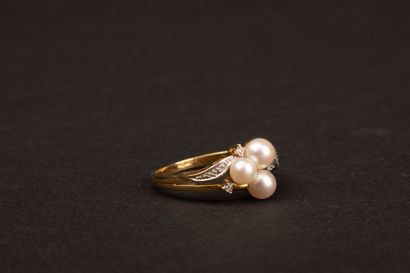 Gold ring set with three cultured pearls...