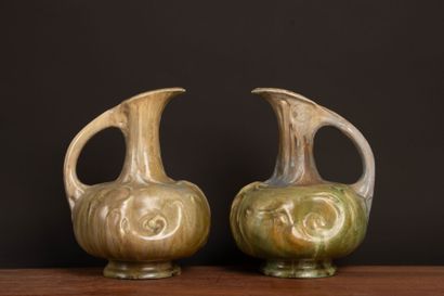 Pair of glazed stoneware pitchers.
Designed...