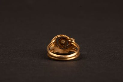 Twisted gold ring set with a diamond weighing...