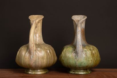 Pair of glazed stoneware pitchers.
Designed...
