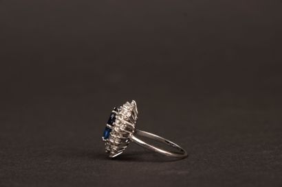 White gold ring set with an oval sapphire...