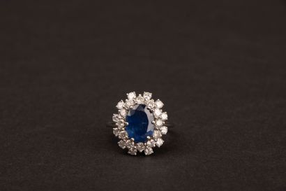 White gold ring set with an oval sapphire...