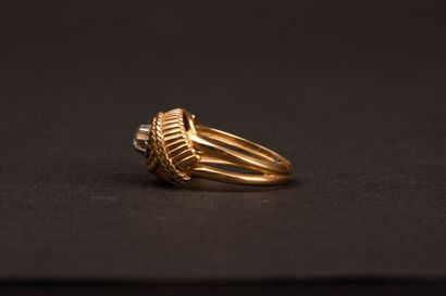 Twisted gold ring set with a diamond weighing...