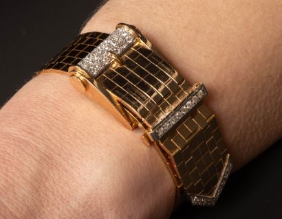 Gold wristwatch featuring a belt motif, accented...
