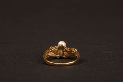 Gold ring set with three cultured pearls...