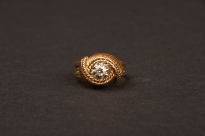 Twisted gold ring set with a diamond weighing...