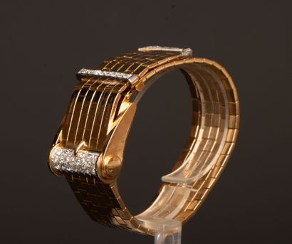 Gold wristwatch featuring a belt motif, accented...