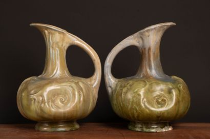 Pair of glazed stoneware pitchers.
Designed...
