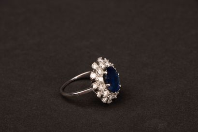 White gold ring set with an oval sapphire...