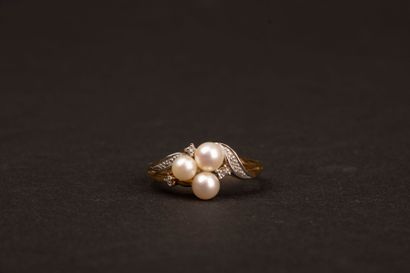 Gold ring set with three cultured pearls...