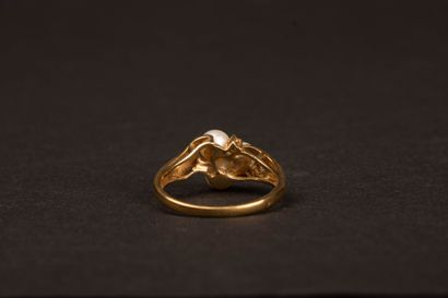 Gold ring set with three cultured pearls...