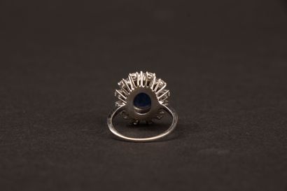 White gold ring set with an oval sapphire...
