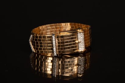 Gold wristwatch featuring a belt motif, accented...