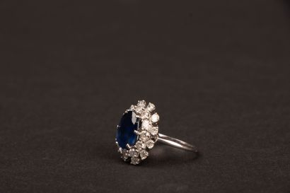 White gold ring set with an oval sapphire...