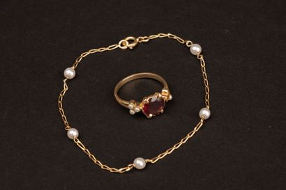 Gold bracelet accented with pearls and a...