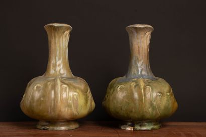 Pair of glazed stoneware pitchers.
Designed...